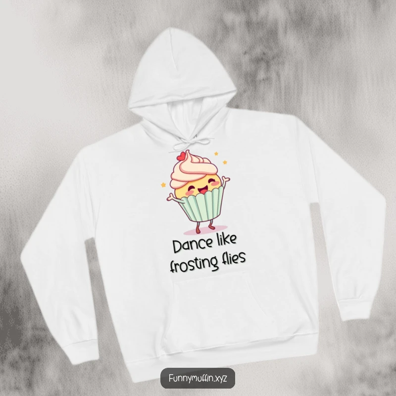 Funny hoodie depicting a joyous cupcake character dancing energetically, frosting flying, creating a warm and humorous vibe.